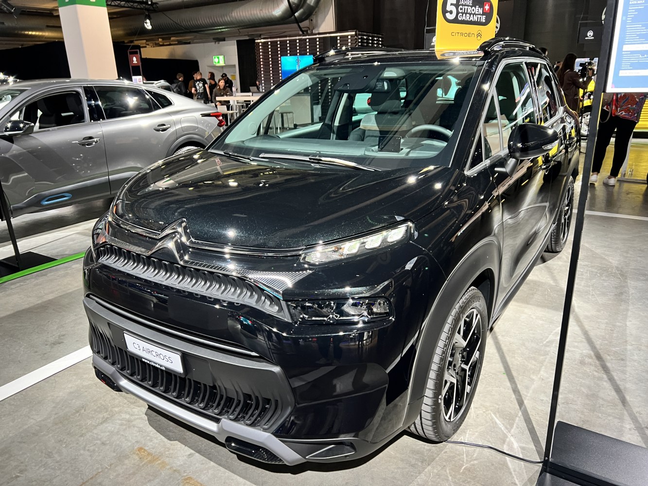Black compact SUV front with sleek headlights and grille design