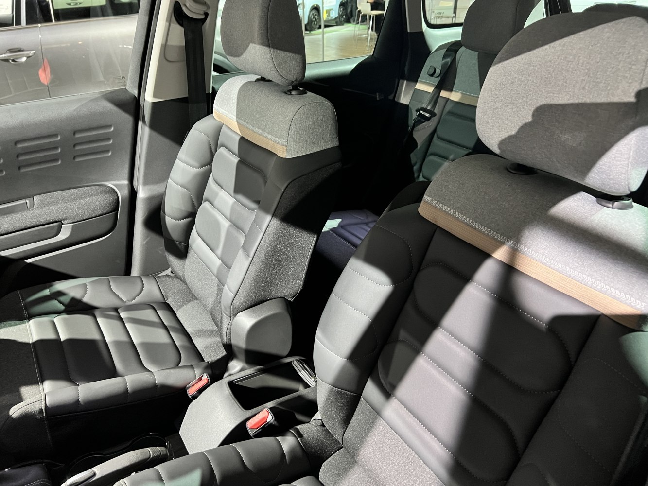 Front seats with modern upholstery and fabric-headrest combination