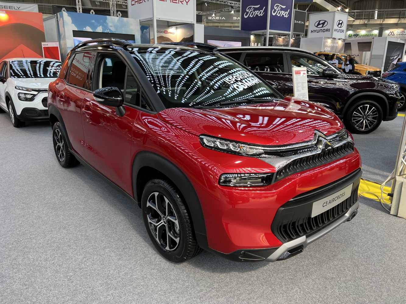 Red compact SUV with LED headlights and bold grille design