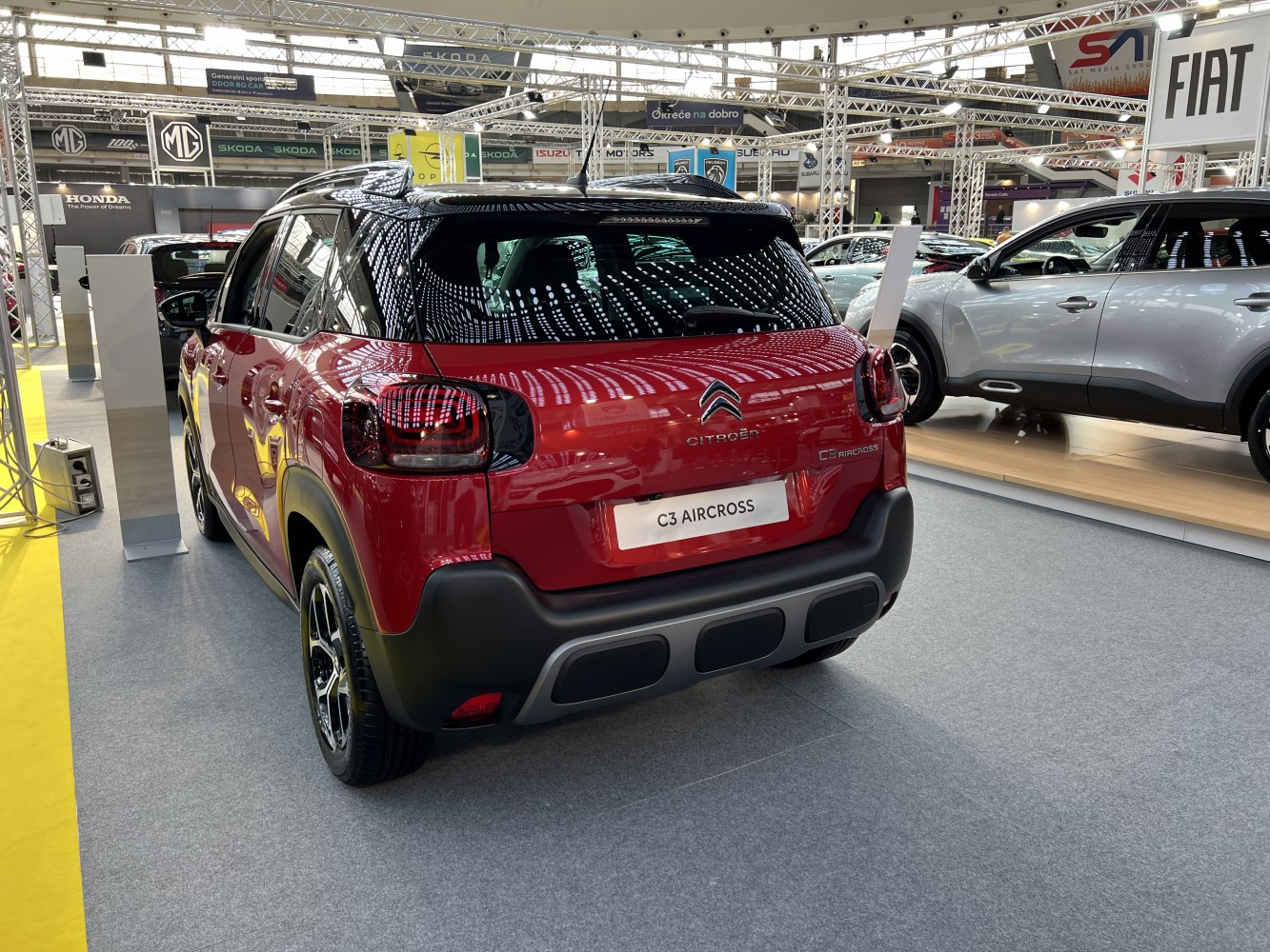 Rear view featuring taillights and sporty bumper of a red compact SUV