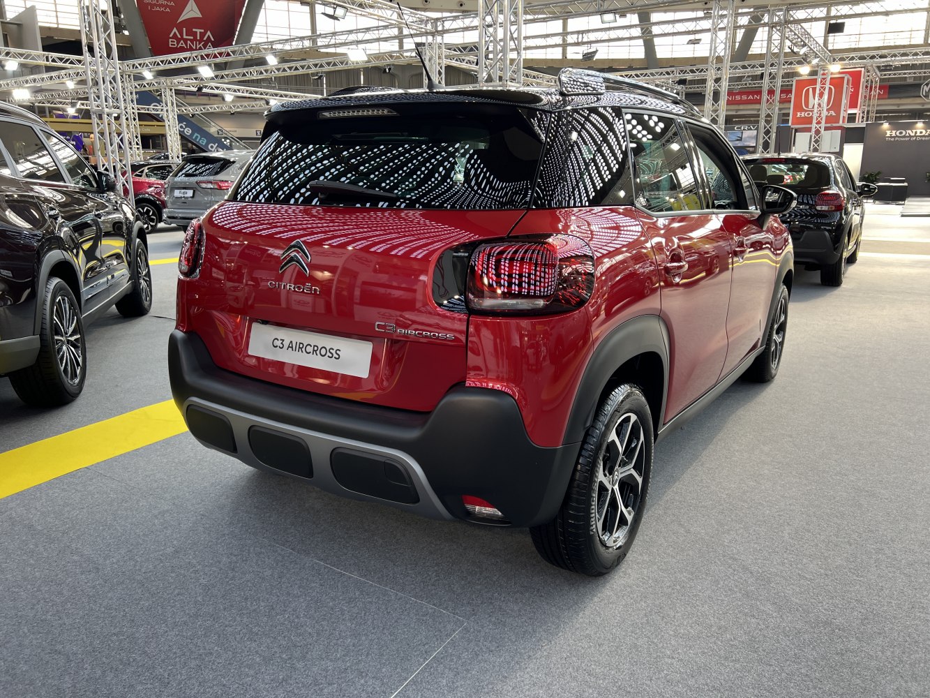 Red compact SUV rear with distinctive taillights and black lower cladding