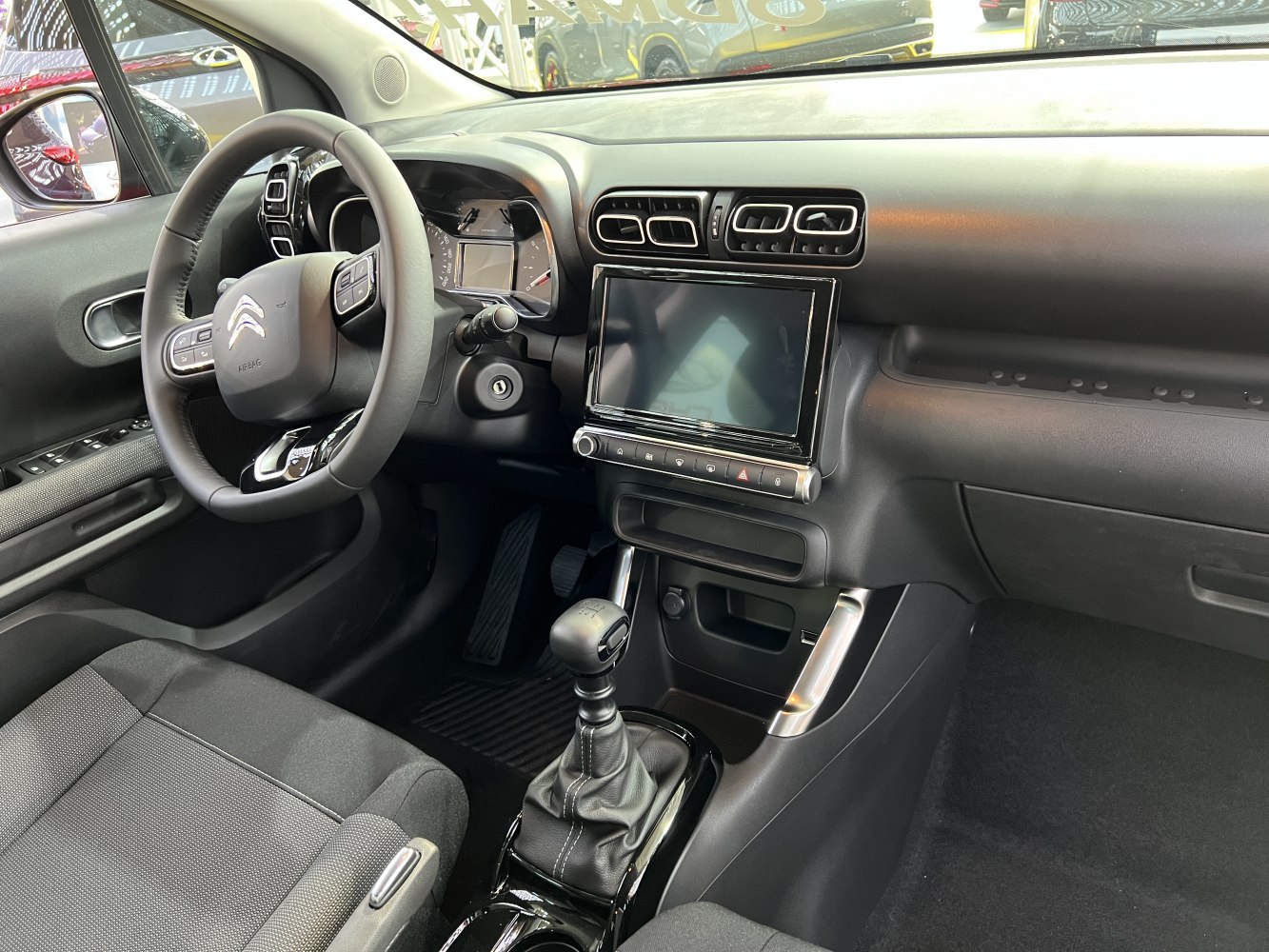 Interior dashboard with steering wheel and manual gearshift