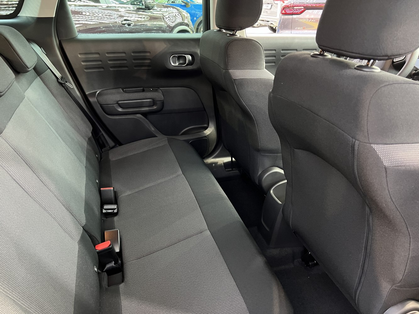 Rear seating area with fabric upholstery and door panel design