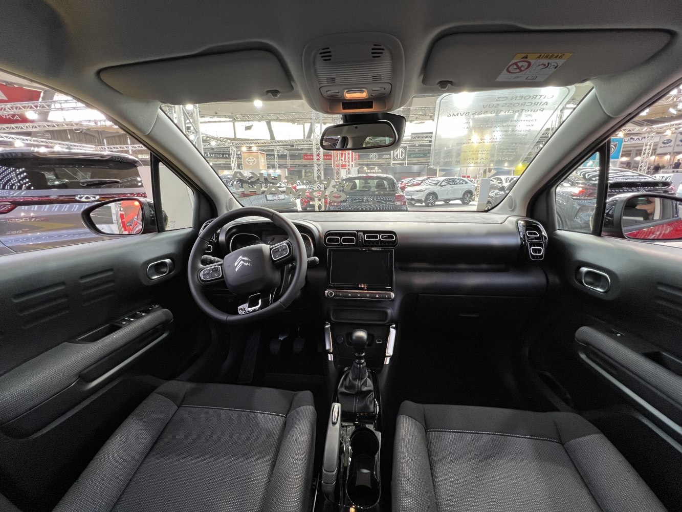 Black dashboard and multifunction steering wheel with fabric seats