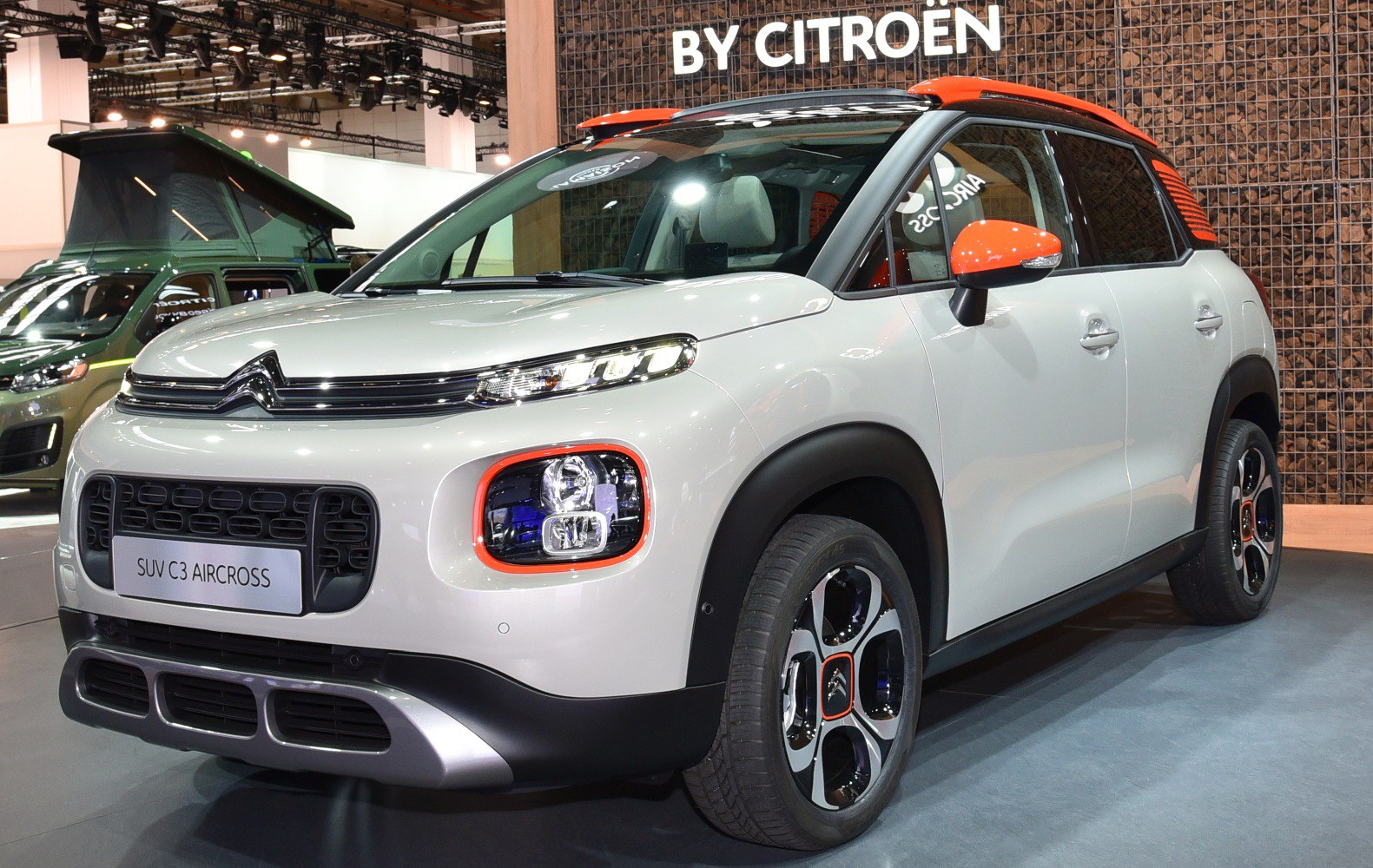 Compact SUV with dual-level headlights and distinctive orange-accented roof rails