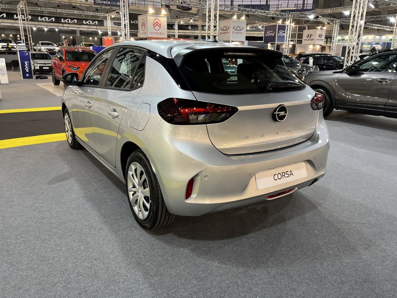 Rear view of a silver modern hatchback with dark taillights and smooth body lines