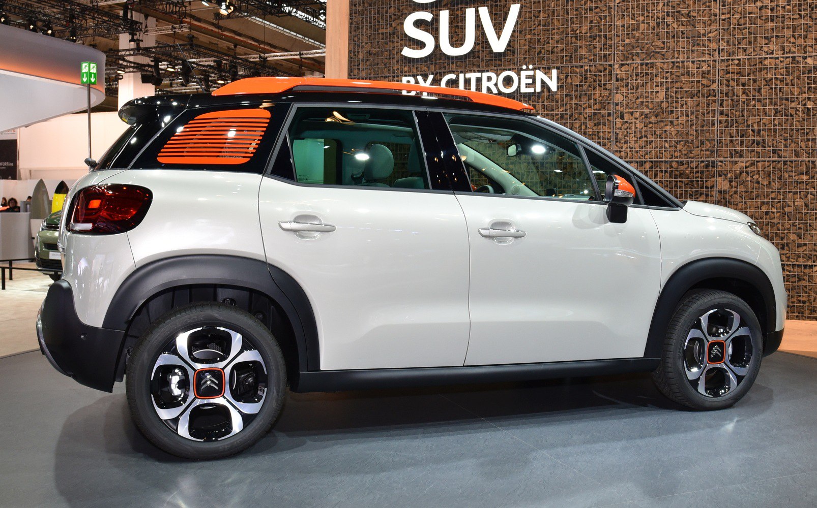 Profile view with orange roof accents and unique alloy wheels