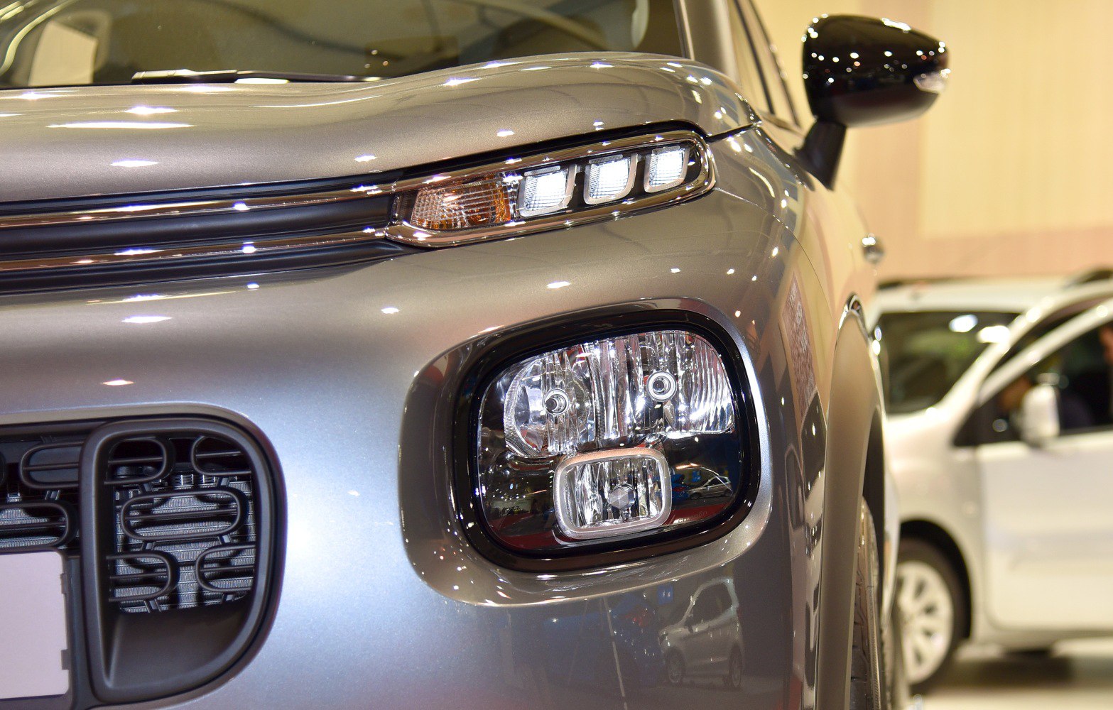 Front headlight cluster and grille close-up with detailed lighting elements