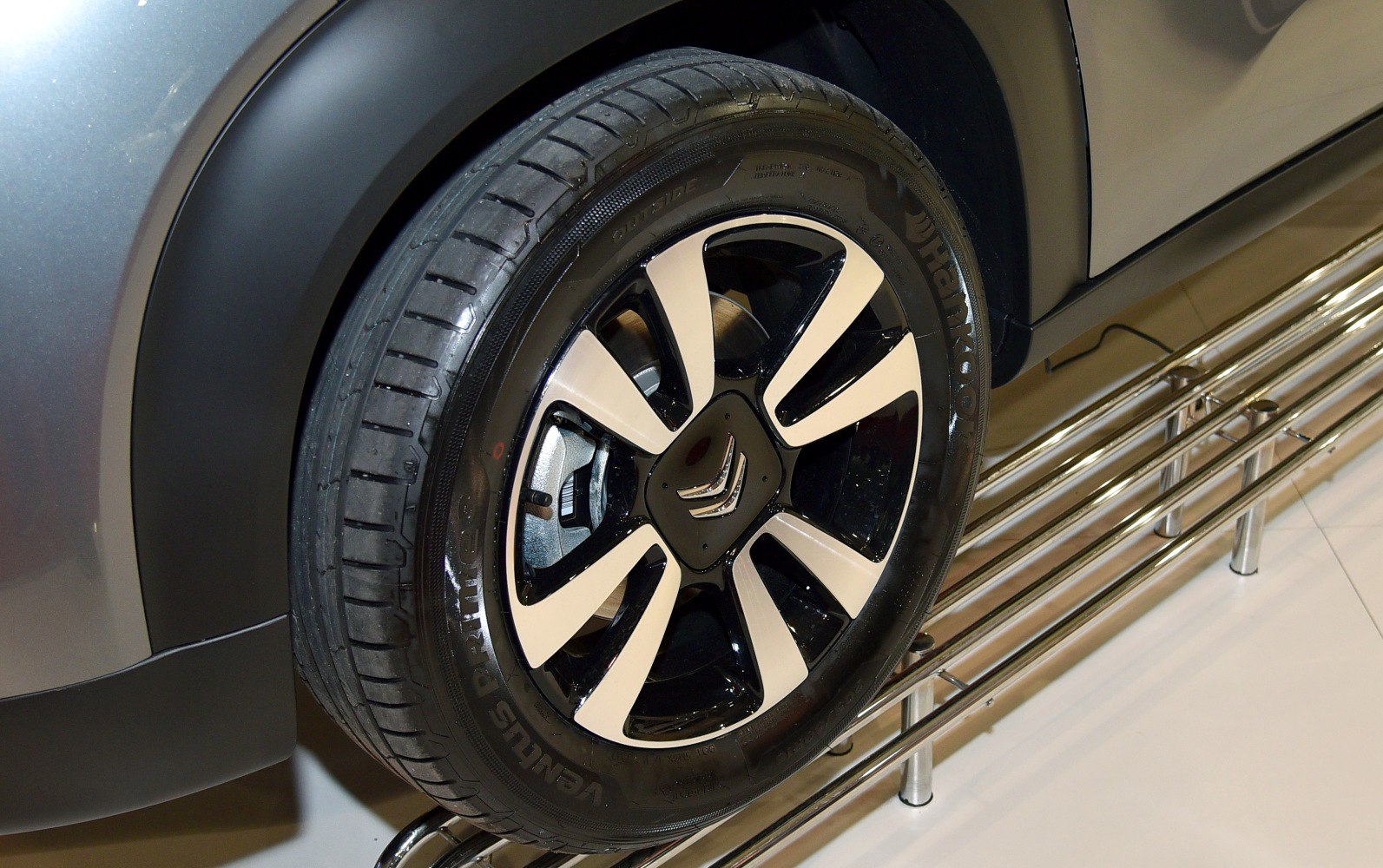 Close-up of alloy wheel and tire with distinctive black and silver design