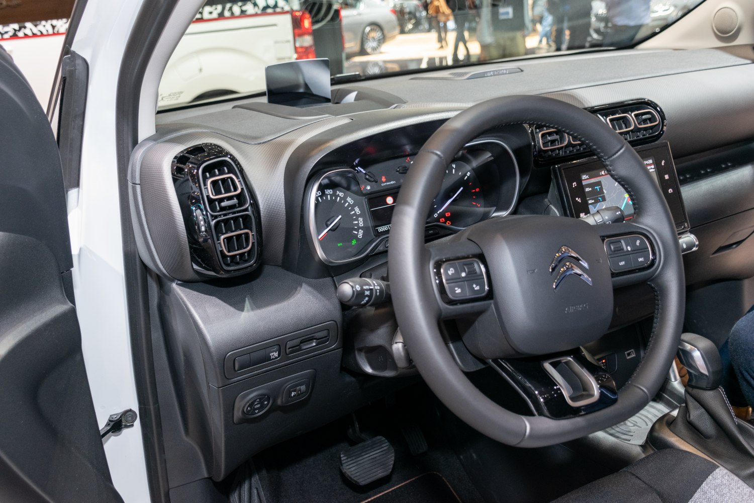 Dashboard and steering wheel with infotainment screen and controls