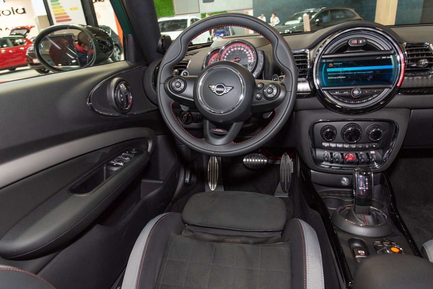 Steering wheel with controls, digital display, and modern dashboard layout