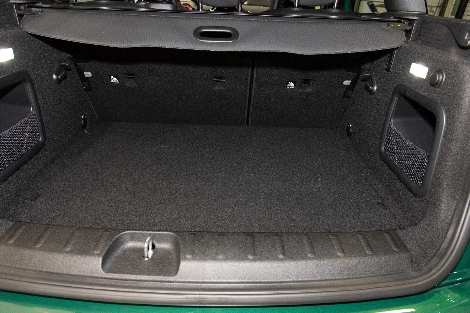Spacious trunk interior with storage nets and protective cover