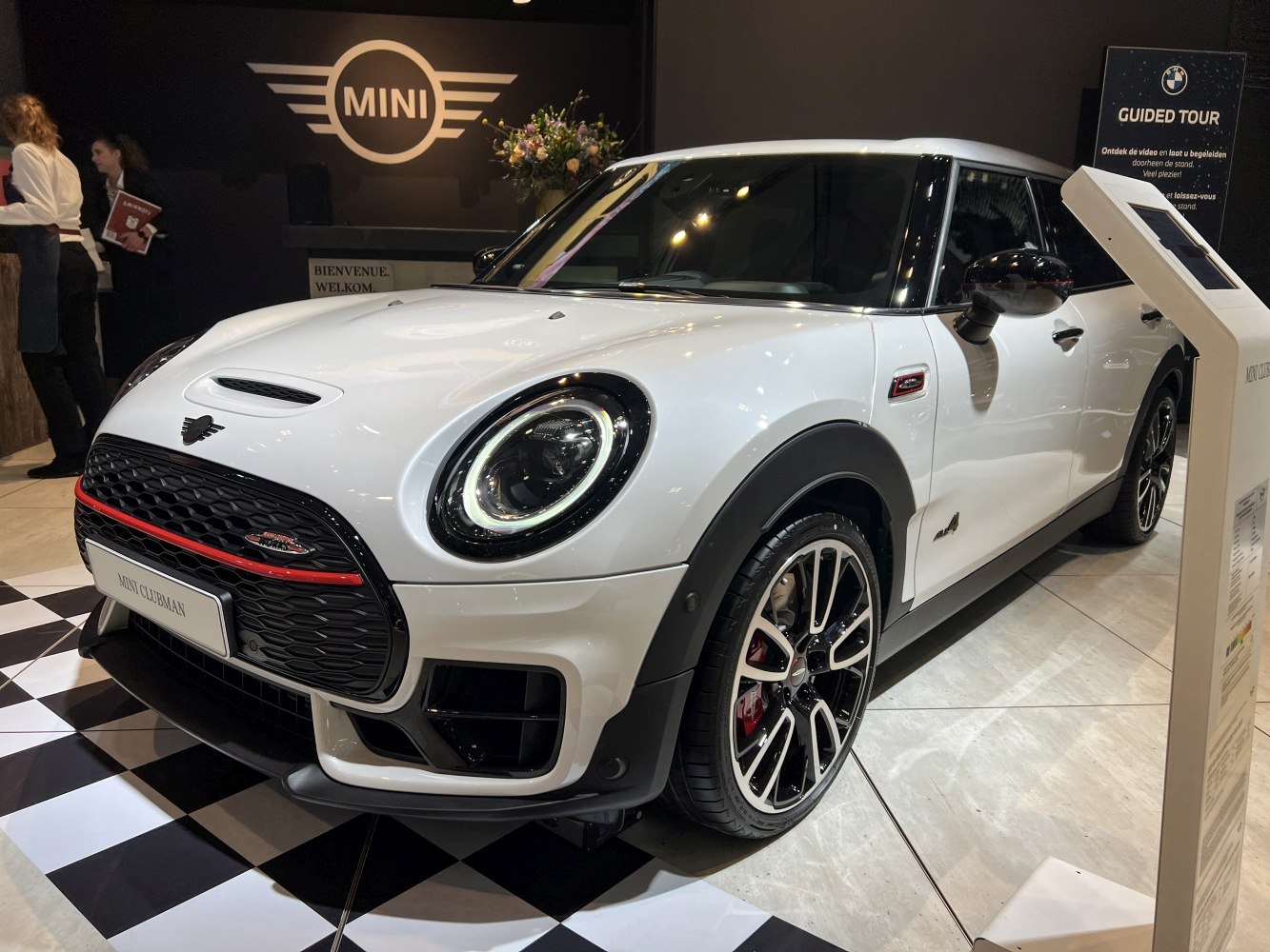 Round LED headlights and sporty front grille in white compact wagon
