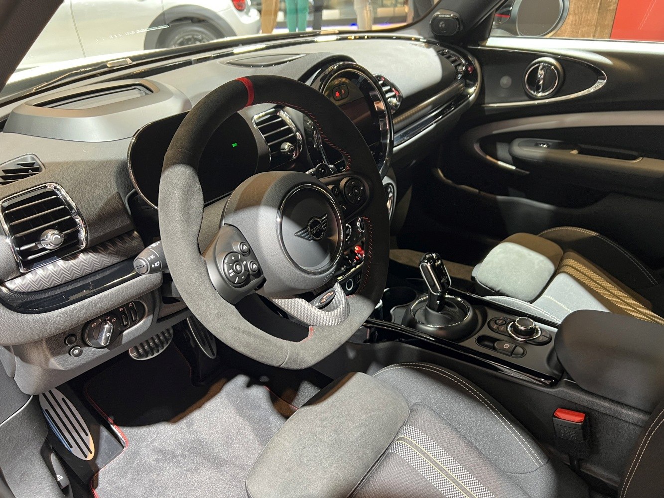 Steering wheel, dashboard, and gear selector of a modern compact car interior