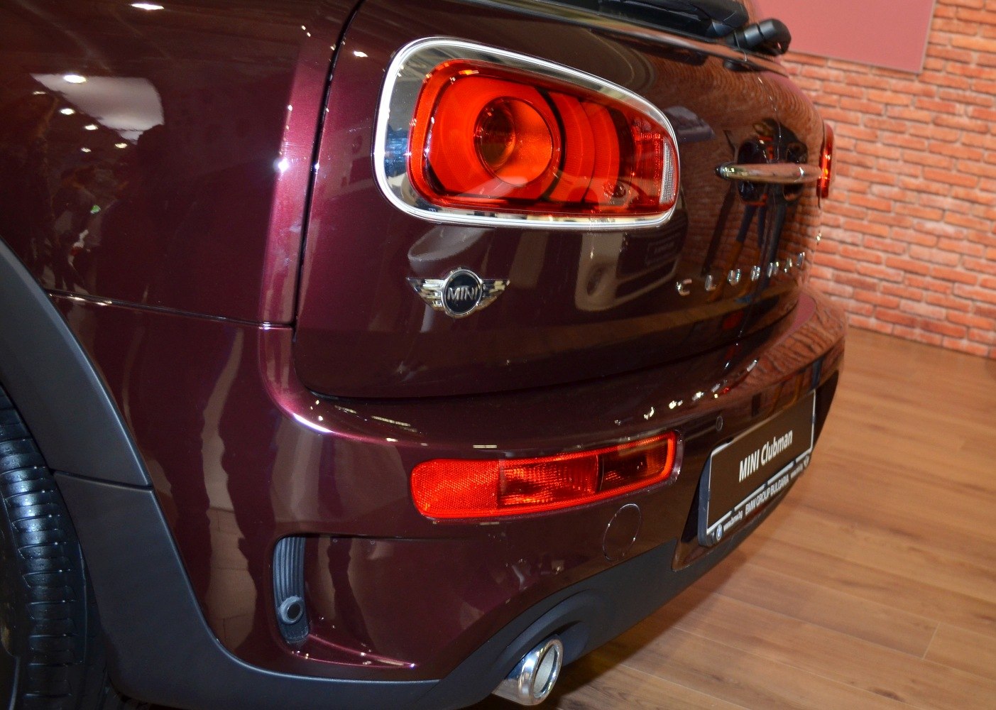 Close-up of rear tail light, badge, bumper and exhaust pipe
