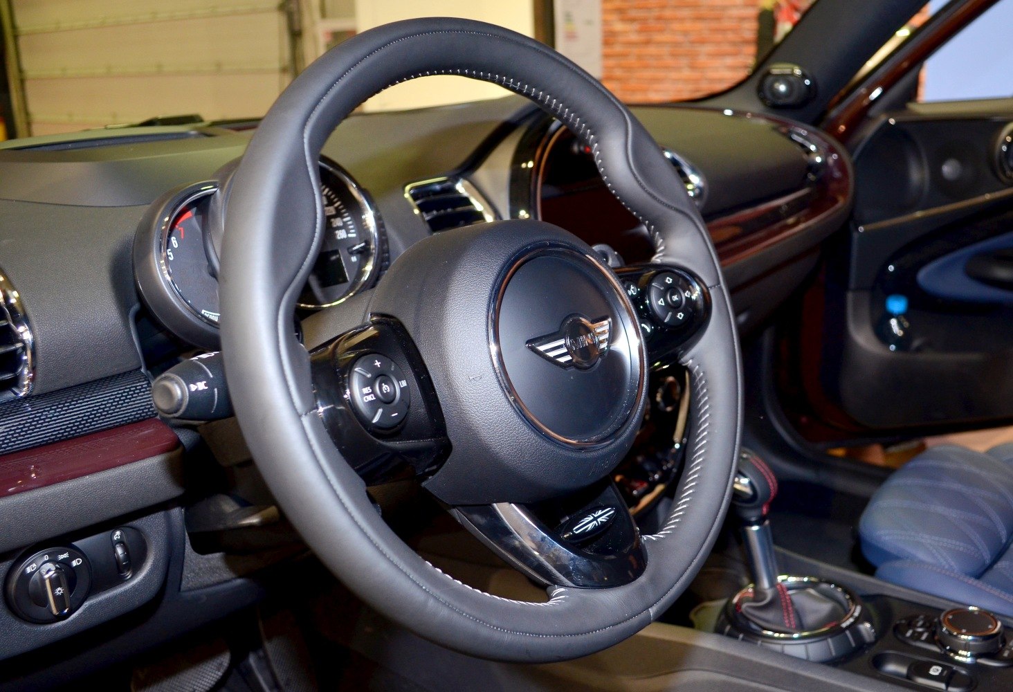 Steering wheel and dashboard controls in a compact car interior
