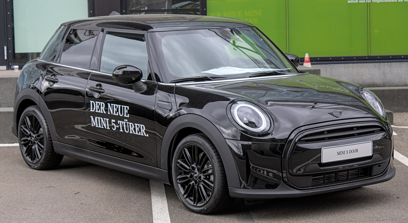 Black hatchback with round headlights and 5-door layout