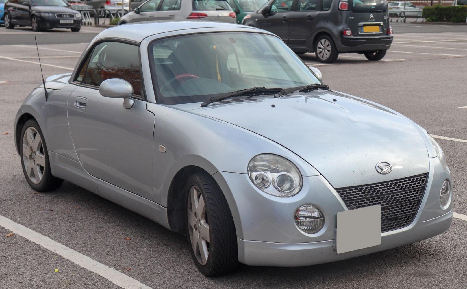 Compact convertible coupe with round headlights and mesh front grille