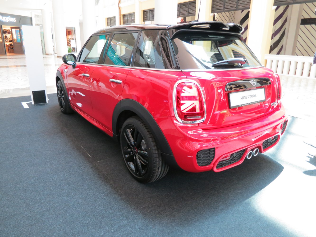 Red 5-door hatch with Union Jack taillights and dual exhaust