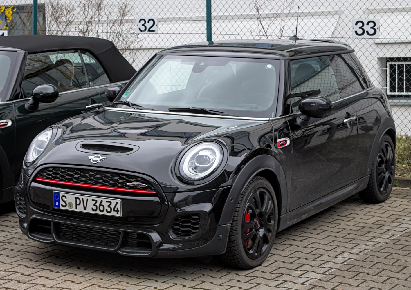 Black 3-door hatchback front with sporty grille and round headlights