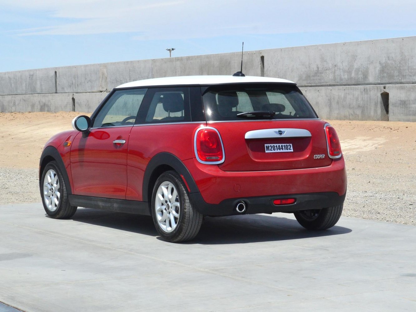 Red 3-door hatchback with white roof and distinctive rear lights
