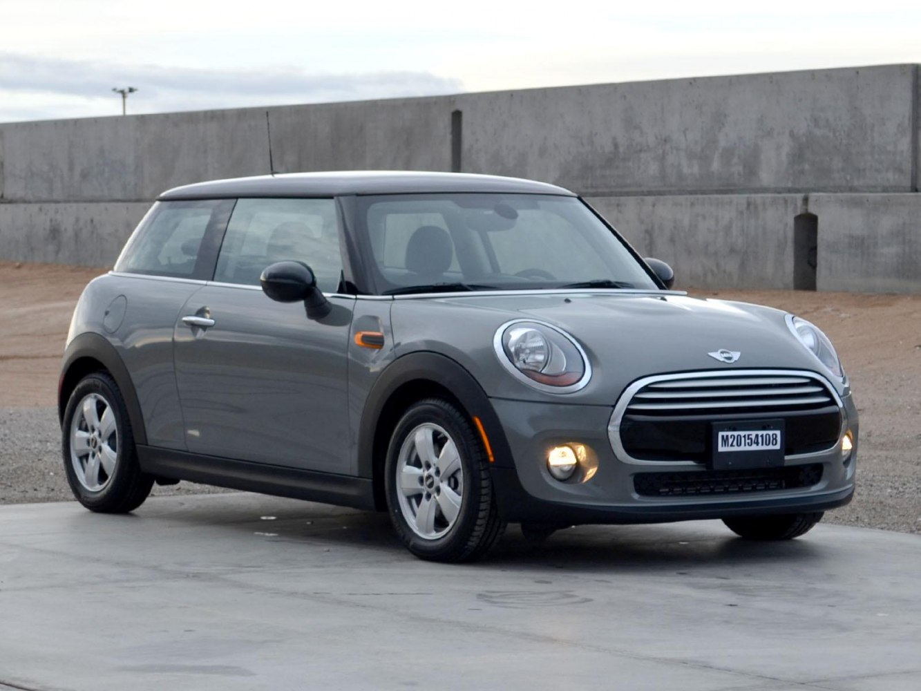 Compact 3-door hatchback with rounded headlights and chrome grille