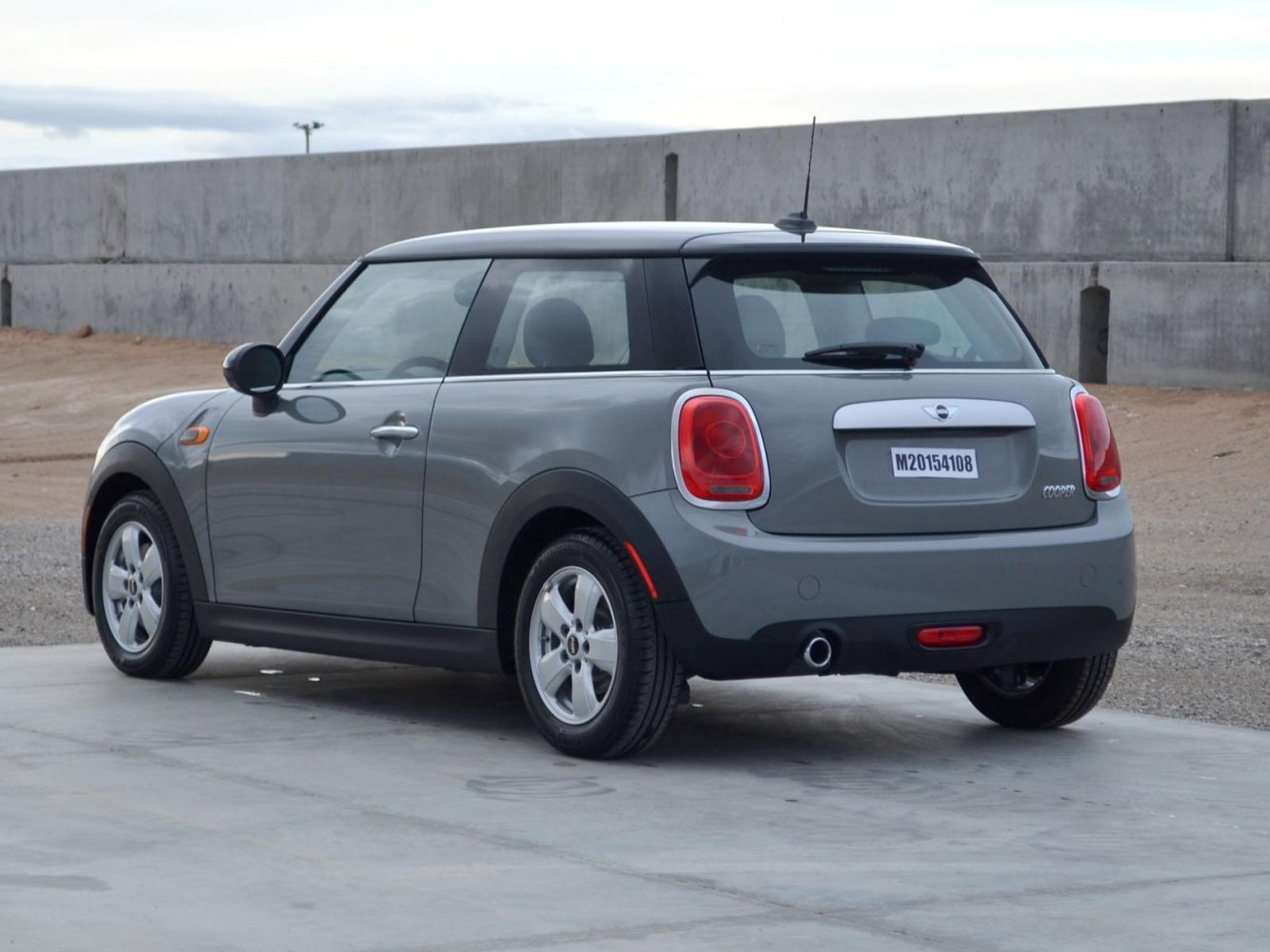 Rear and side view of a compact 3-door hatchback with single exhaust and distinct rear taillights