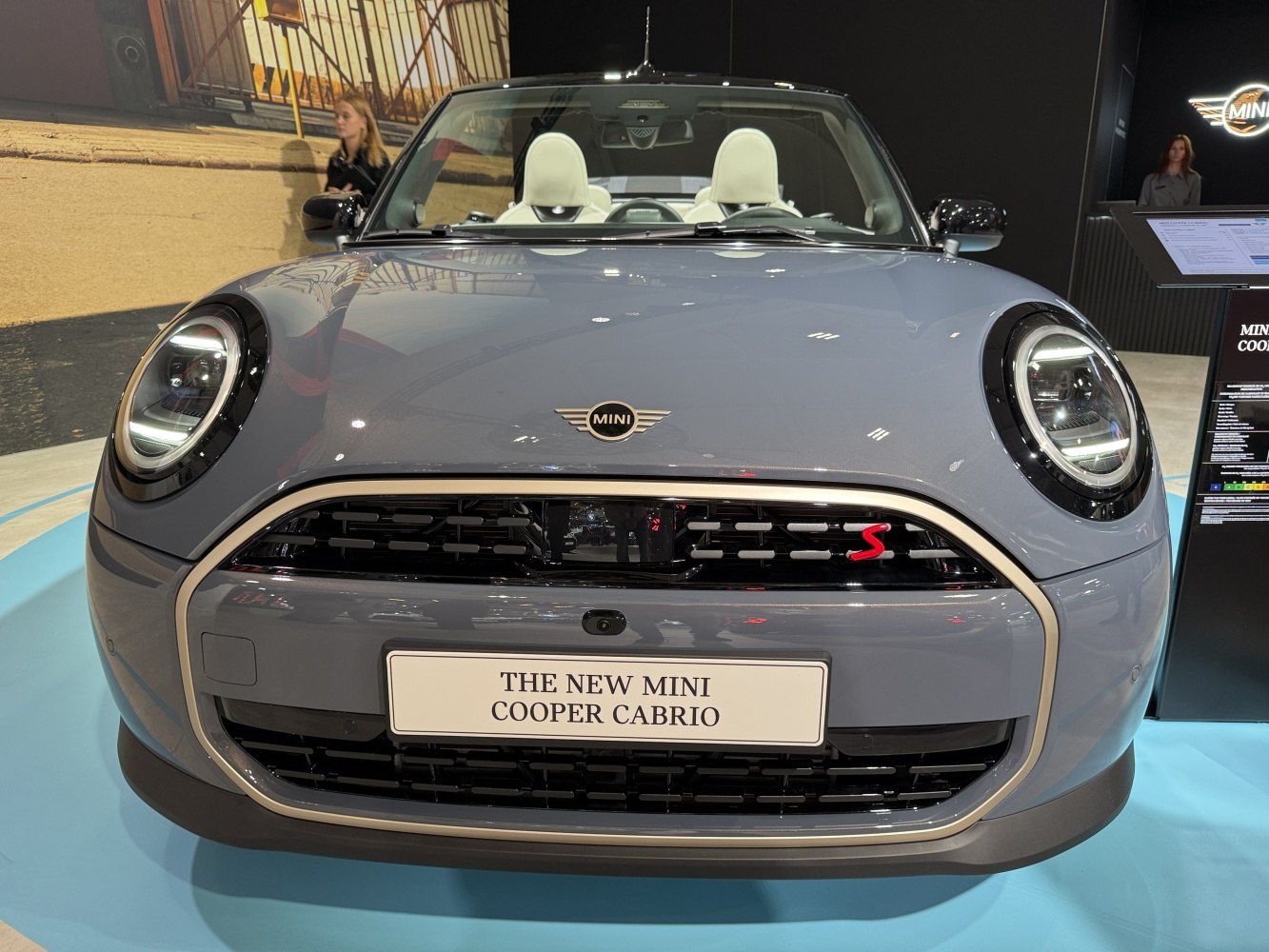 Front view showing round LED headlights and black grille with red 'S' emblem