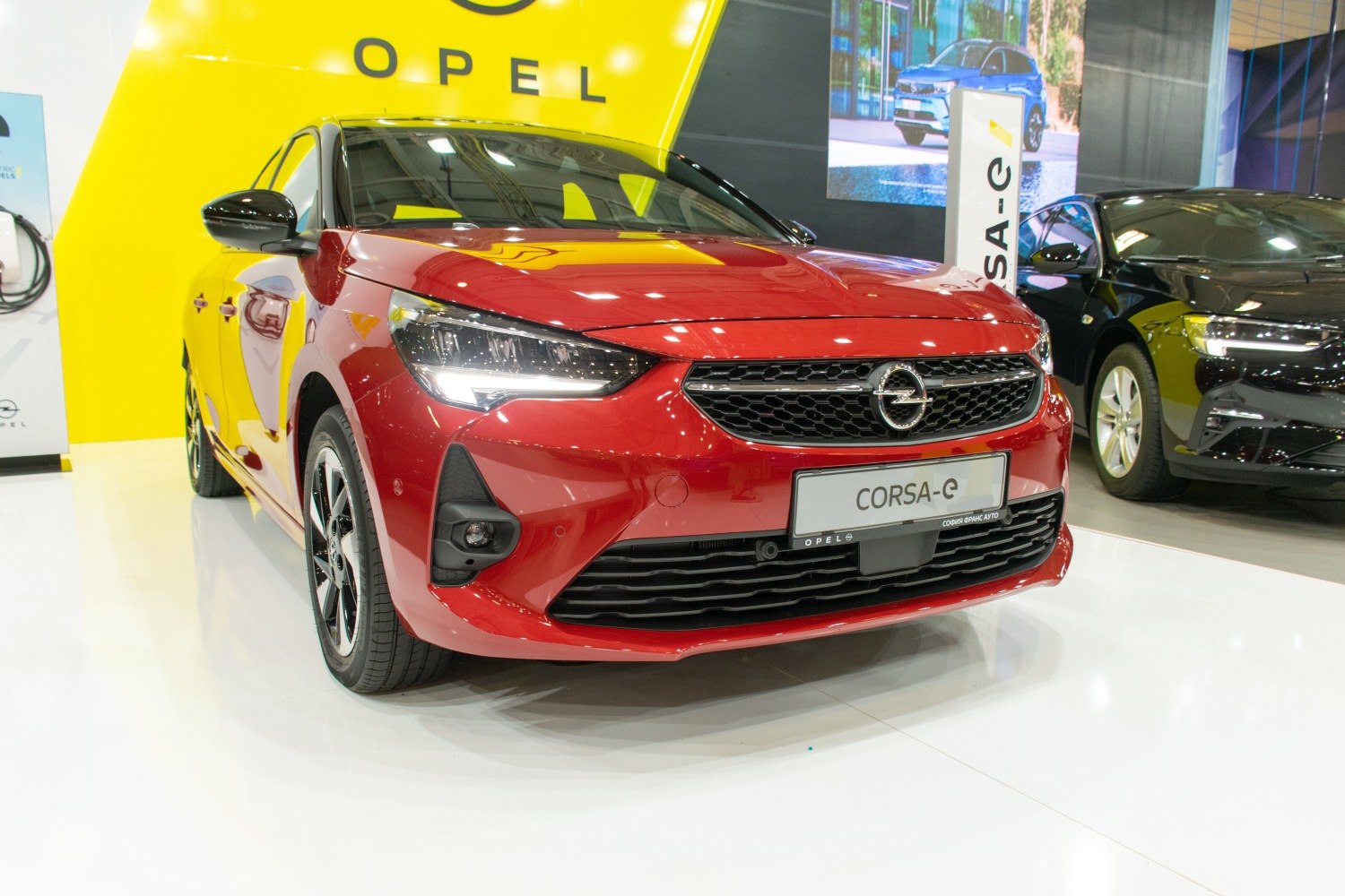 Front view of a red hatchback with LED headlights and hexagonal grill