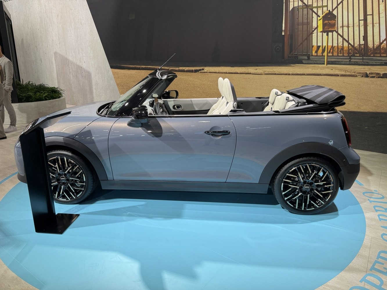 Side view of a convertible with retractable soft top and multi-spoke alloy wheels