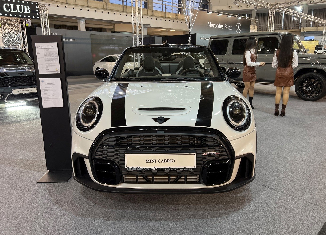 Convertible front view with racing stripes and sporty grille