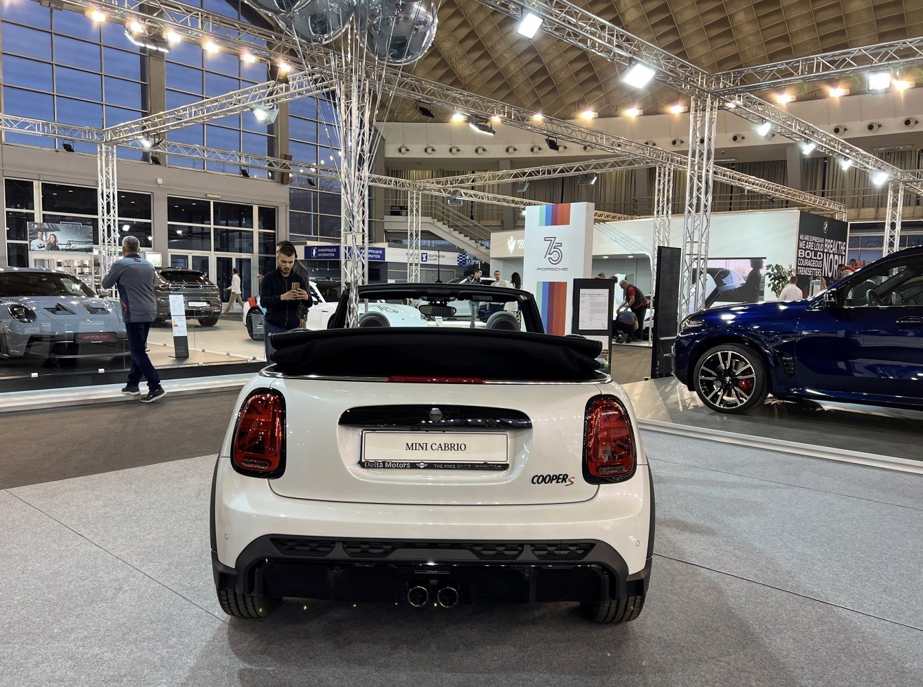 Rear view of Mini Convertible with open soft top and dual exhaust