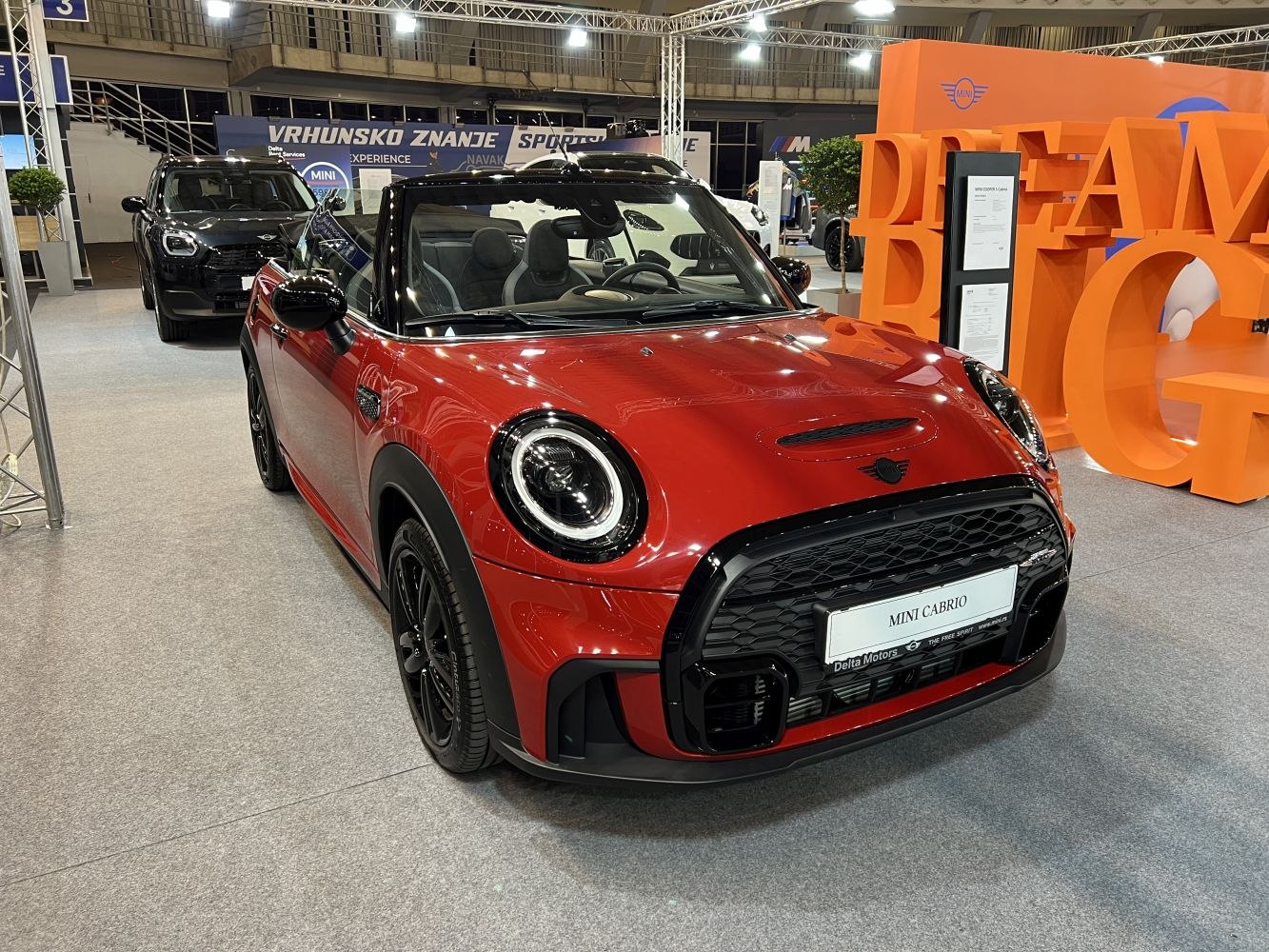 Red convertible with black grille and round LED headlights