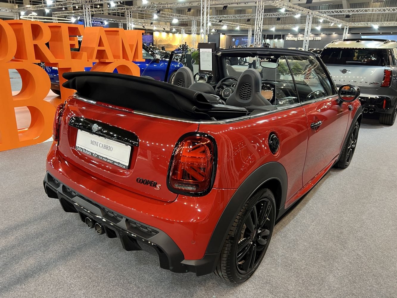 Rear view of convertible with folded soft top and black alloy wheels