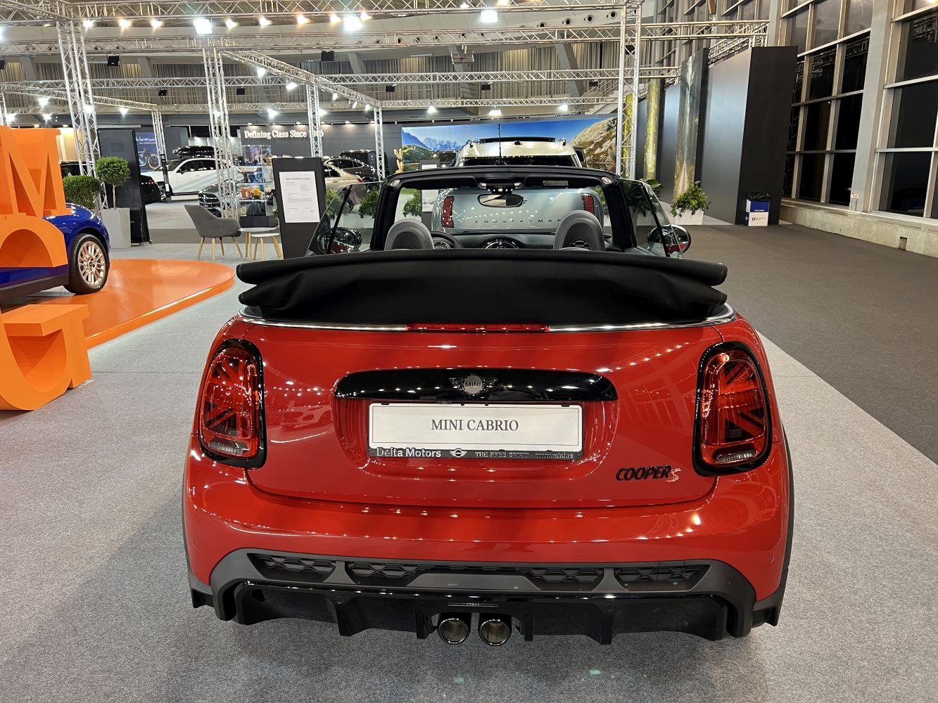 Rear view of convertible with open soft top and dual exhaust
