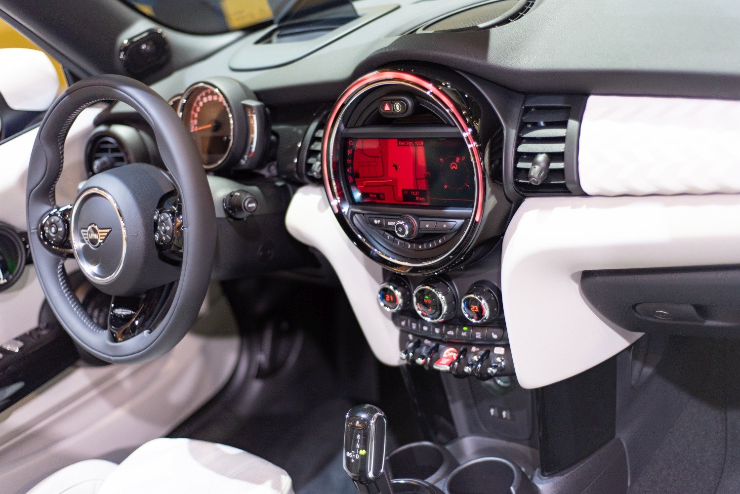 Modern car dashboard with circular infotainment display and climate controls