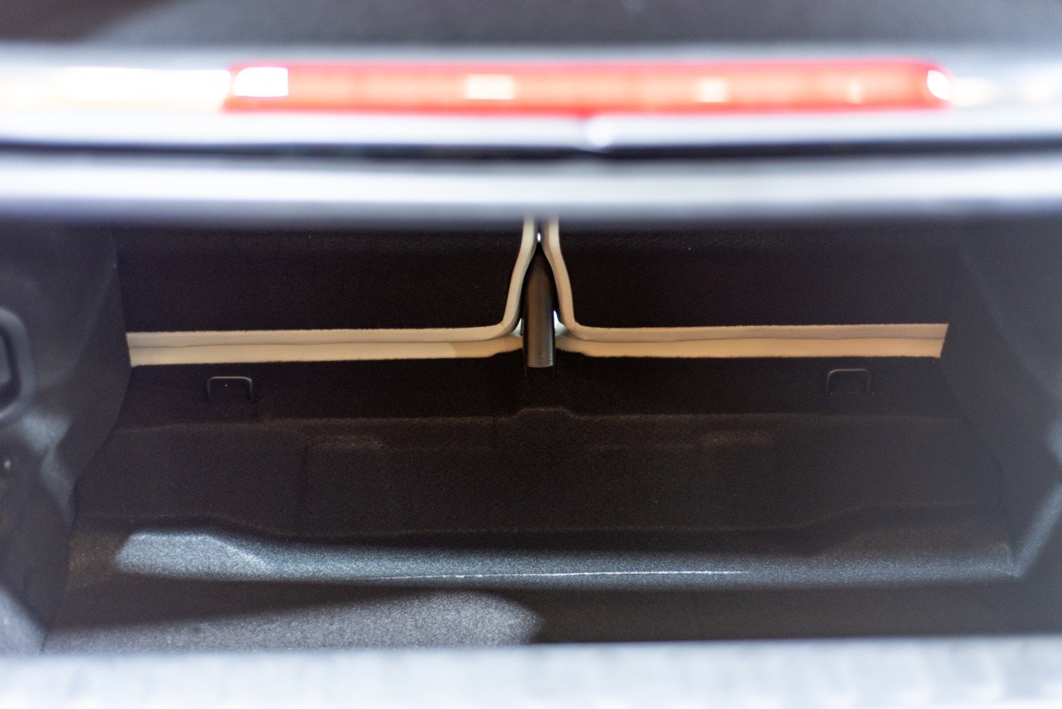 Spacious trunk interior with carpeted surface and black materials