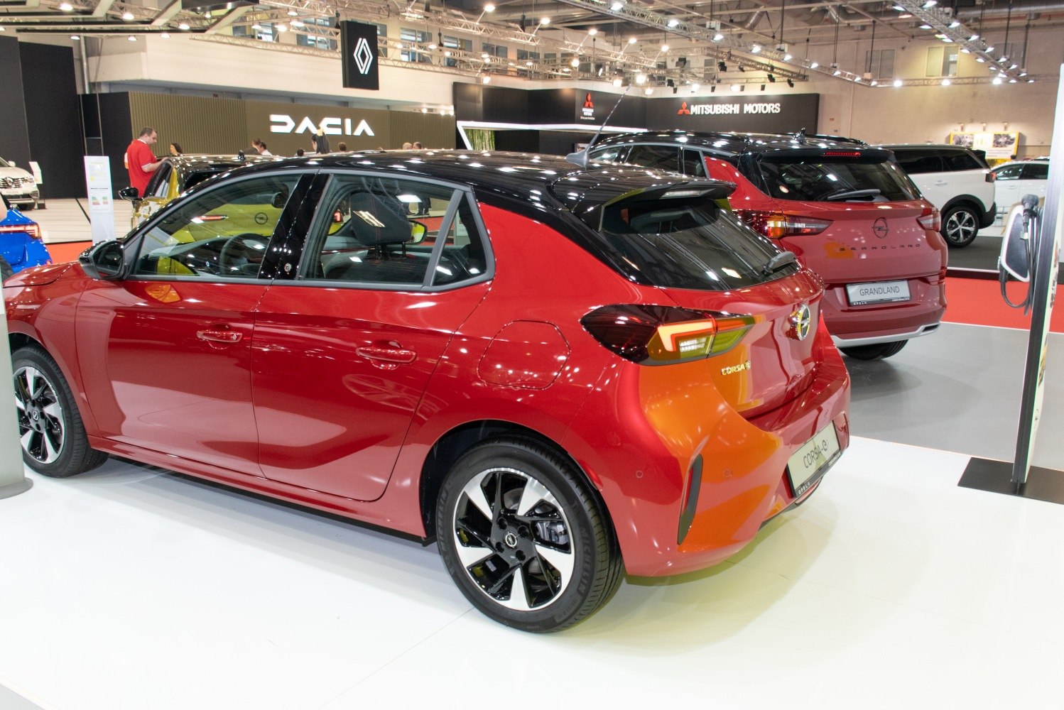Rear side view of red and black two-tone hatchback with alloy wheels