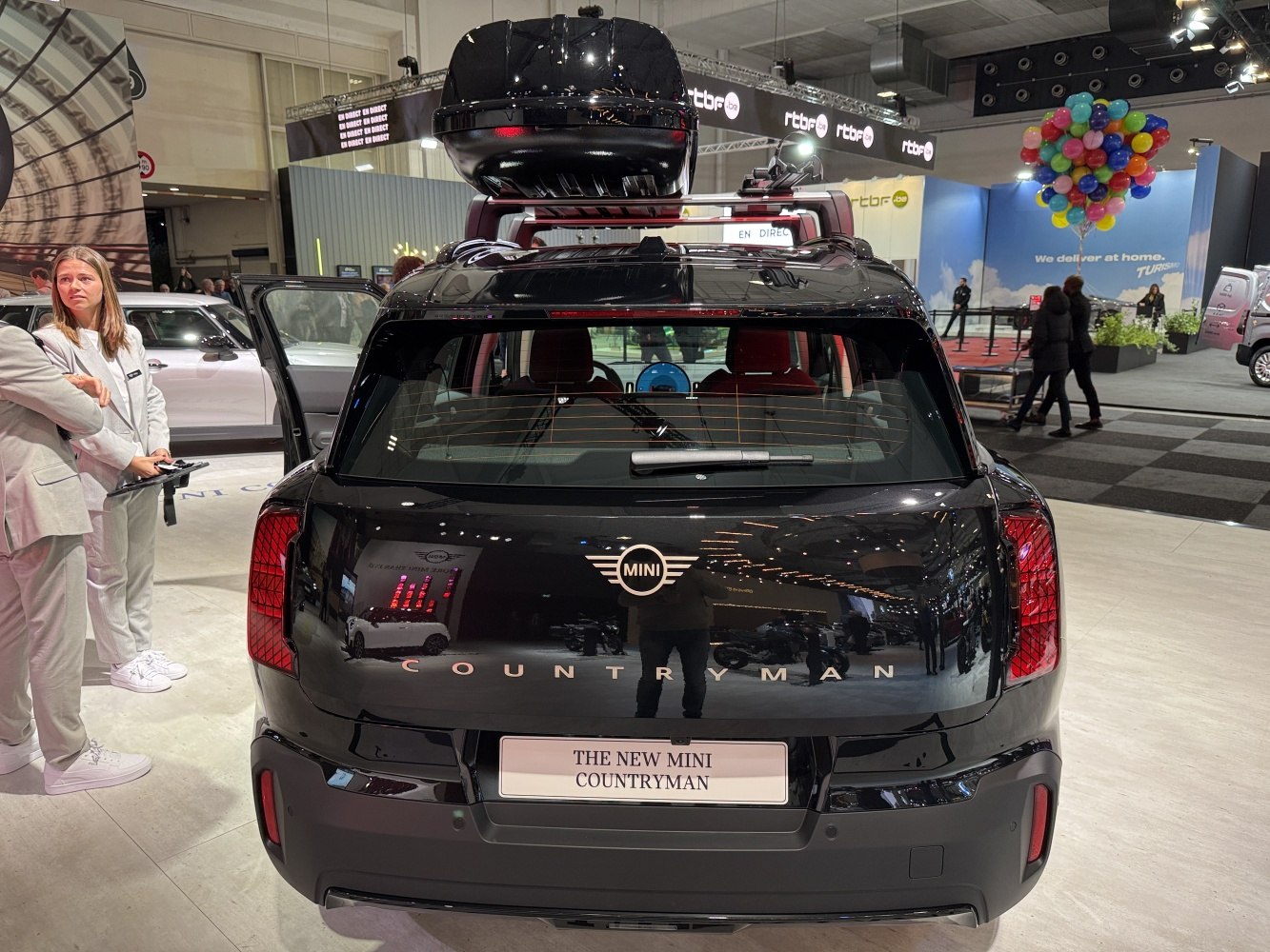 Rear view of a modern SUV with roof box and distinct taillights