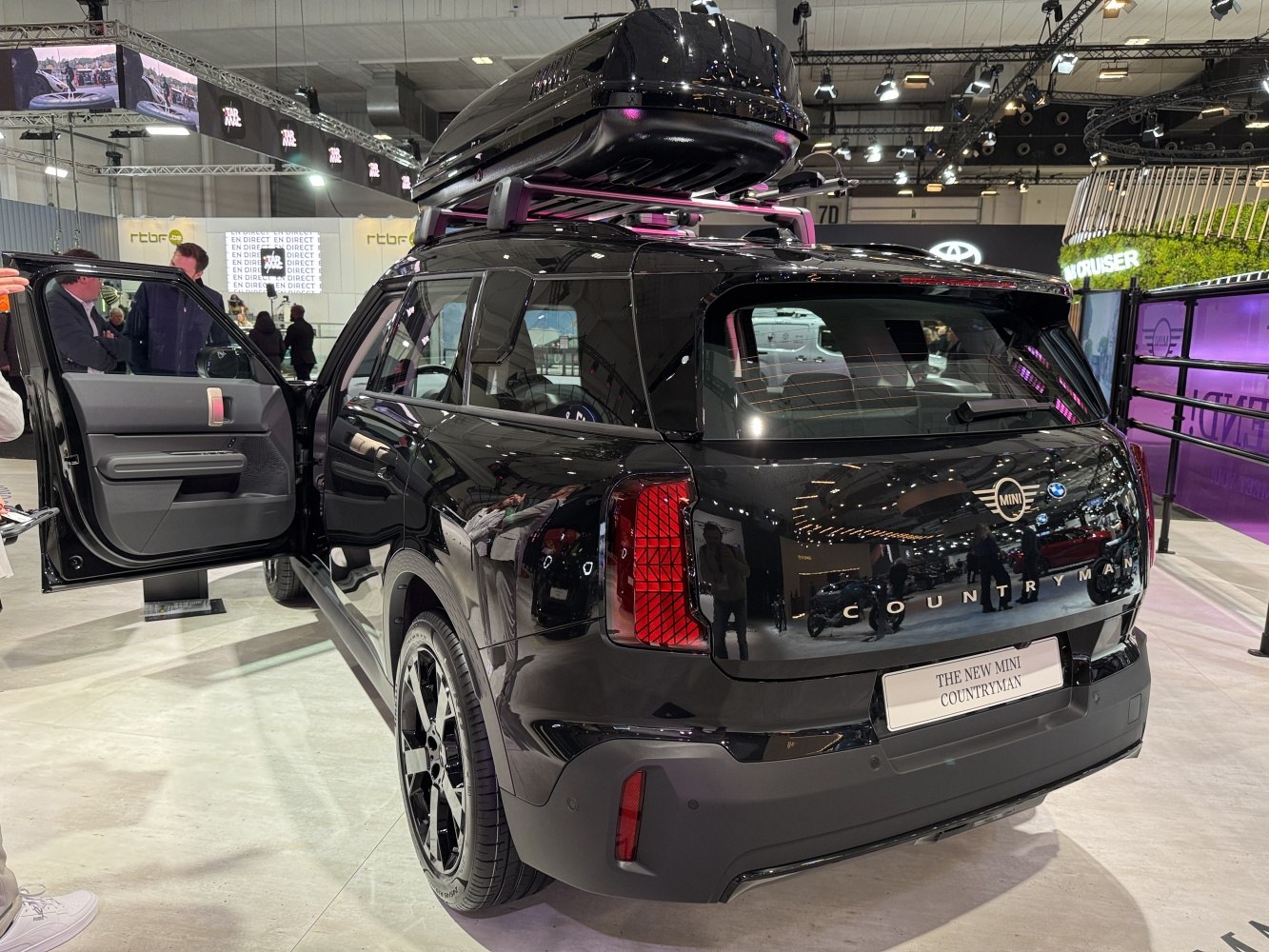 Rear view of an SUV with roof storage box