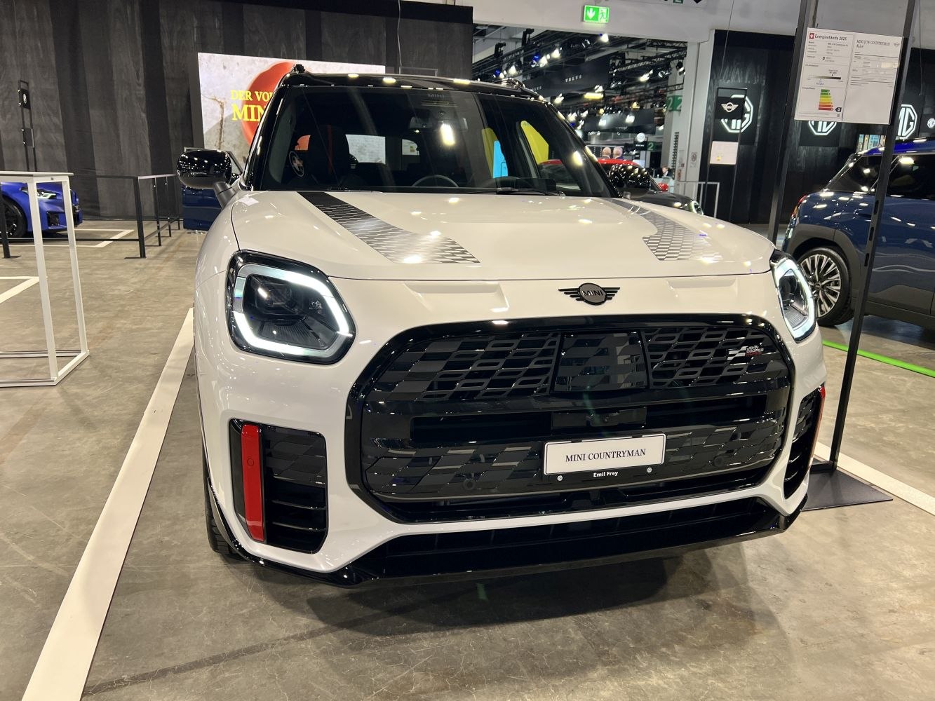 Front view with LED headlights, bold black grille, and sporty hood stripes