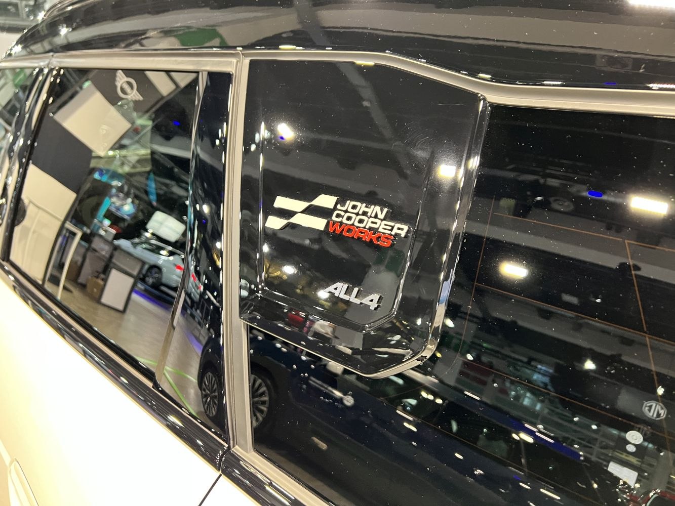 Close-up of John Cooper Works and ALL4 badges on side window