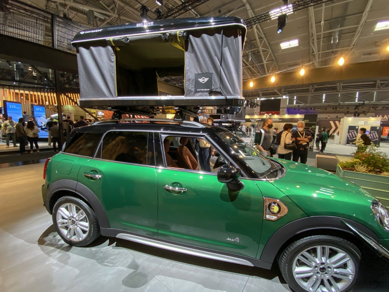 Green SUV with rooftop camping tent setup