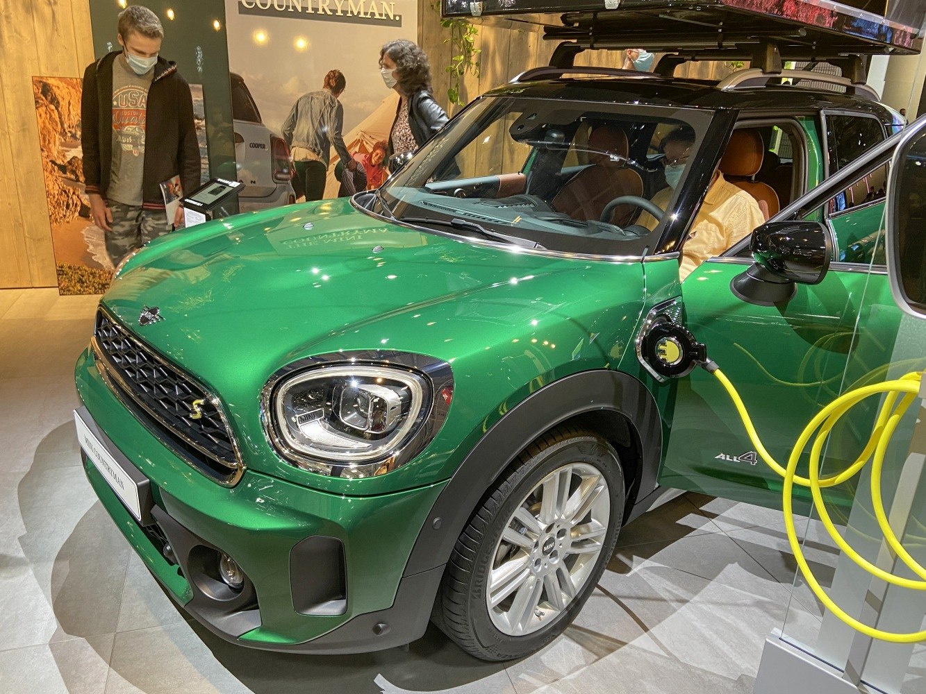 Plug-in hybrid Mini SUV charging with LED headlights and roof rack