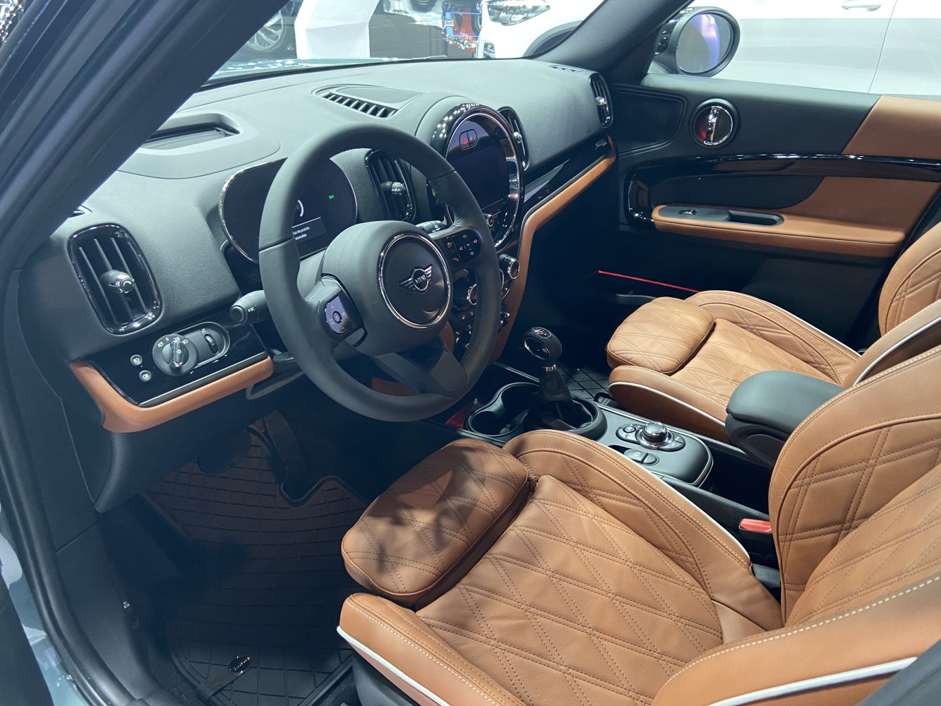 Diamond-stitched brown leather seats and modern dashboard with steering wheel