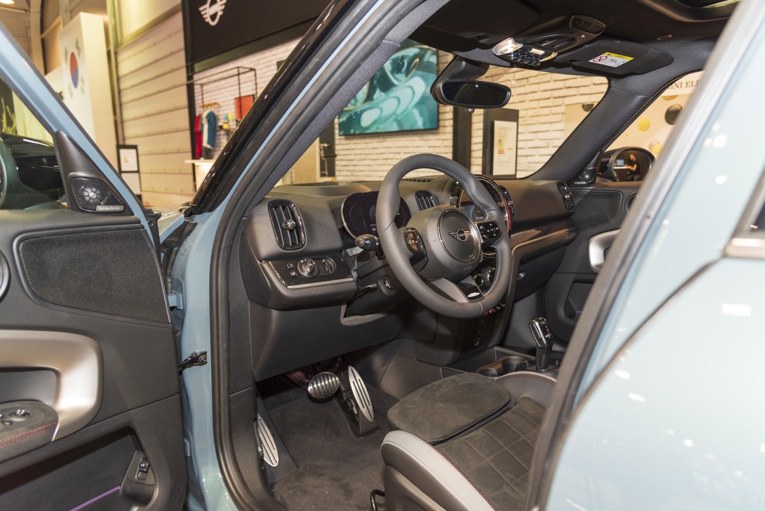 Modern car interior with dashboard, steering wheel, and pedals