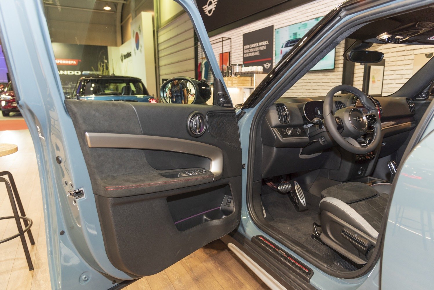 Open driver door showing door panel and steering wheel inside vehicle