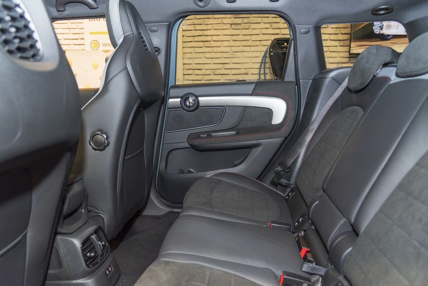 Rear seat interior with leather and suede upholstery, modern door panel.