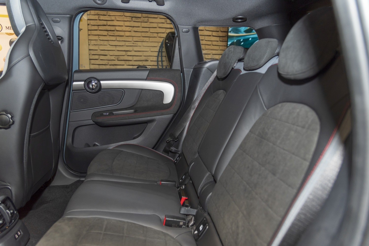 Rear seat interior with leather and suede upholstery and door panel design