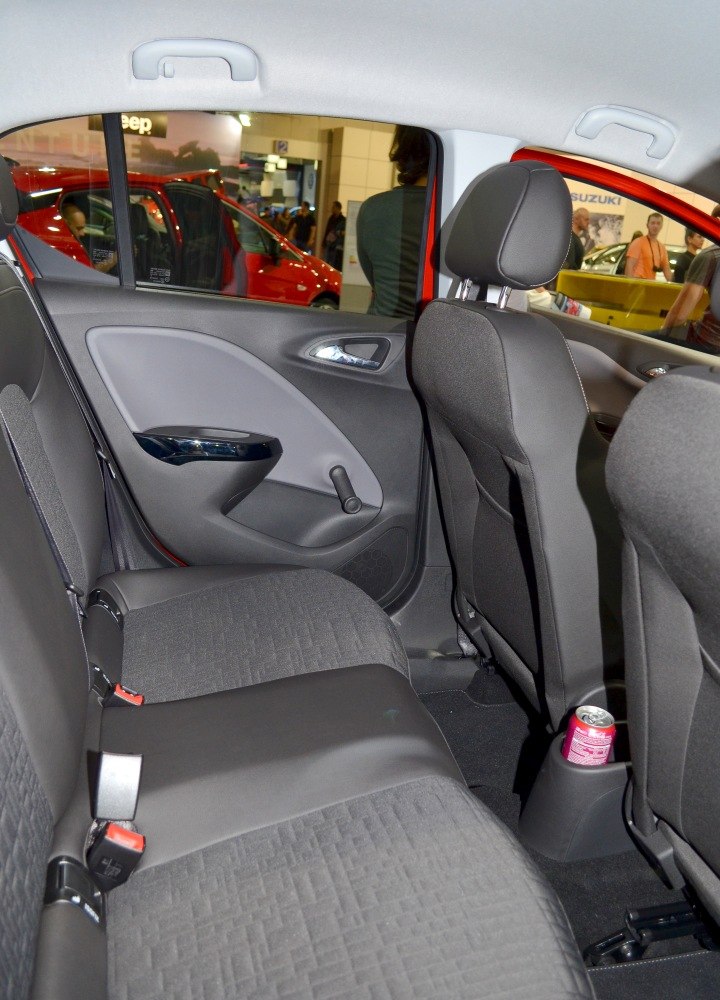 Rear seat with fabric upholstery, manual window crank, and cup holder.